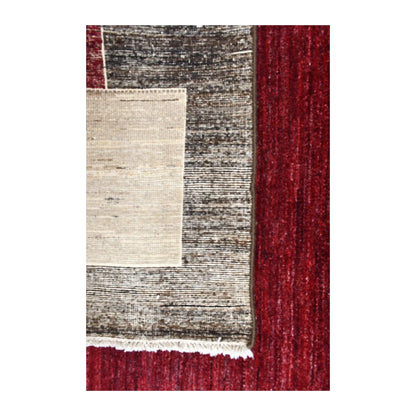 Folded-corner detail of Afghan Gabbeh rug showing the reverse weave, tonal front pile and off-white corner block