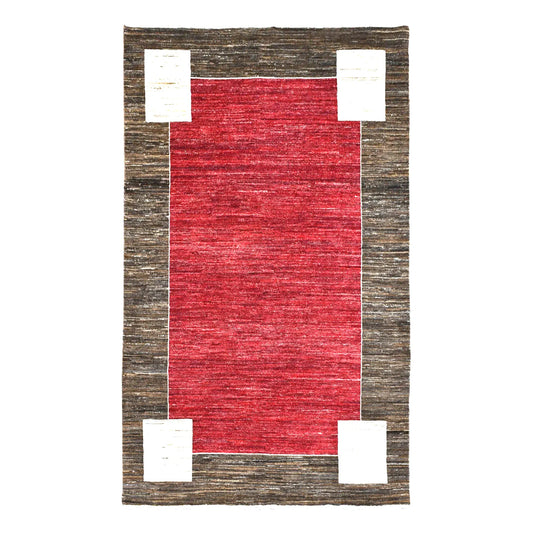 Full view of Afghan Gabbeh hand-knotted wool rug with tonal red field, charcoal-brown frame and off-white corner blocks, 243 x 162 cm
