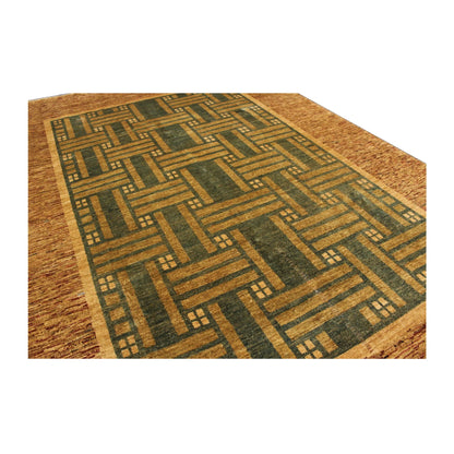 Close-up of Afghan Gabbeh hand-knotted rug showing green geometric field and brown wool detail