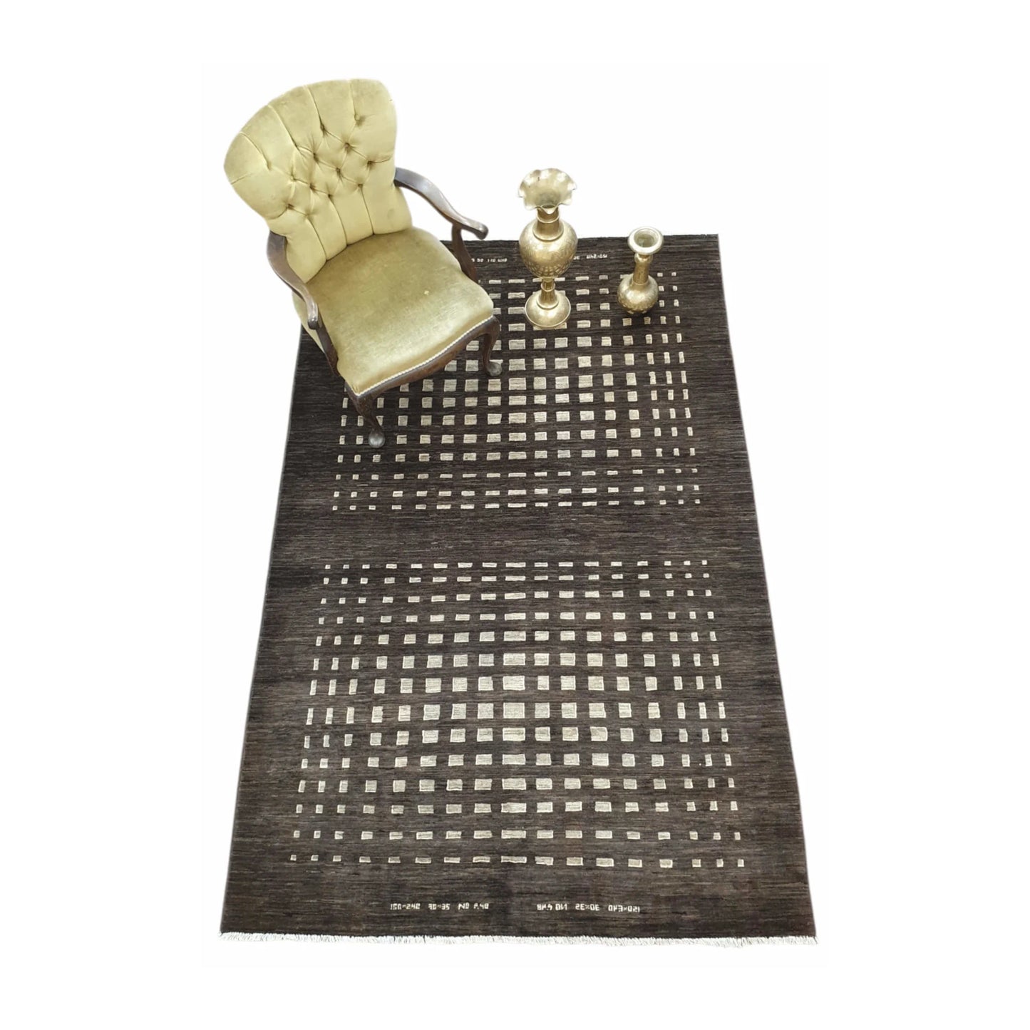 Styled full view of Afghan Gabbeh natural wool rug with dark brown geometric lattice design and decorative objects