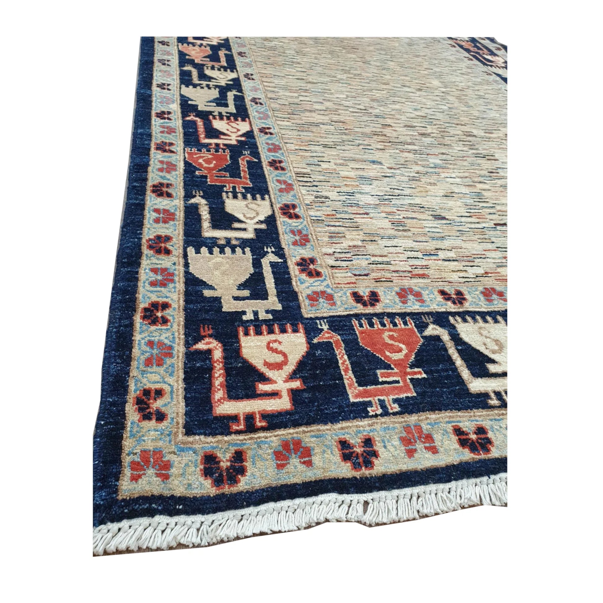 Angled corner detail of Afghan Gabbeh rug showing the deep navy border, muted terracotta accents and visible fringe