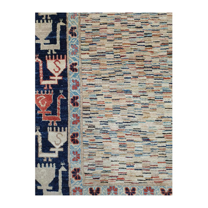 Close-up of Afghan Gabbeh wool rug showing the variegated multicolour field and deep navy side border with stylised motifs