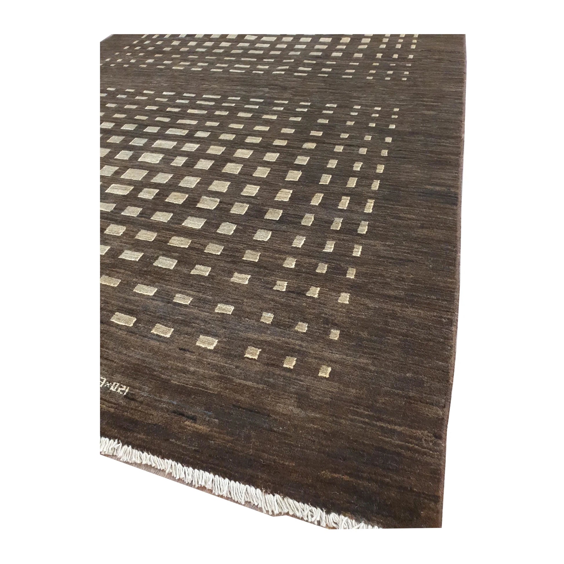 Angled close-up of Afghan Gabbeh rug showing the ivory square lattice pattern, dark brown border and fringe edge
