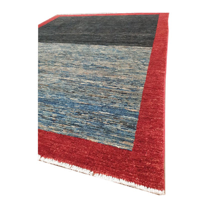 Corner-edge and fringe detail of Afghan Gabbeh wool rug with red border and blue field, 196 x 157 cm