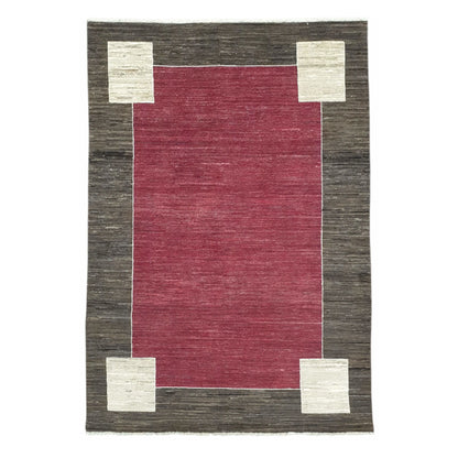 Full view of Afghan Gabbeh hand-knotted wool rug with red field, charcoal-brown border and off-white corner motifs, 243 x 162 cm