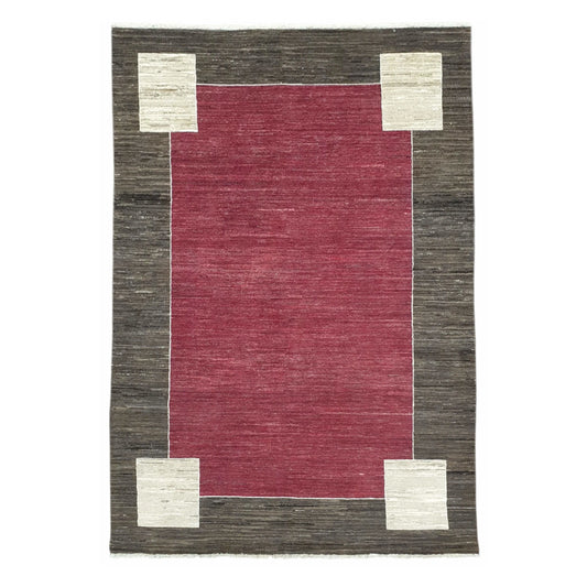 Full view of Afghan Gabbeh hand-knotted wool rug with red field, charcoal-brown border and off-white corner motifs, 243 x 162 cm