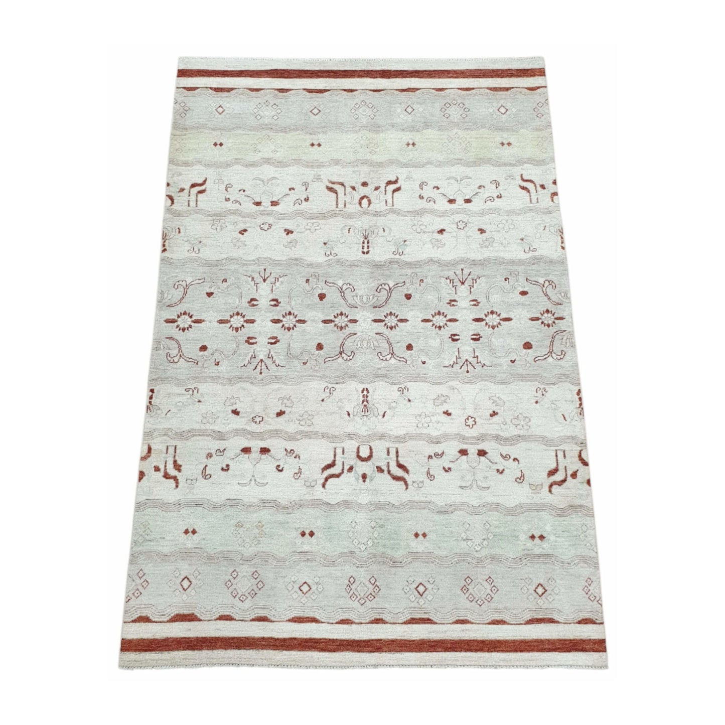 Angled full view of Afghan Gabbeh wool rug showing tonal horizontal bands, rust-red motifs and soft off-white wool pile, 250 x 168 cm