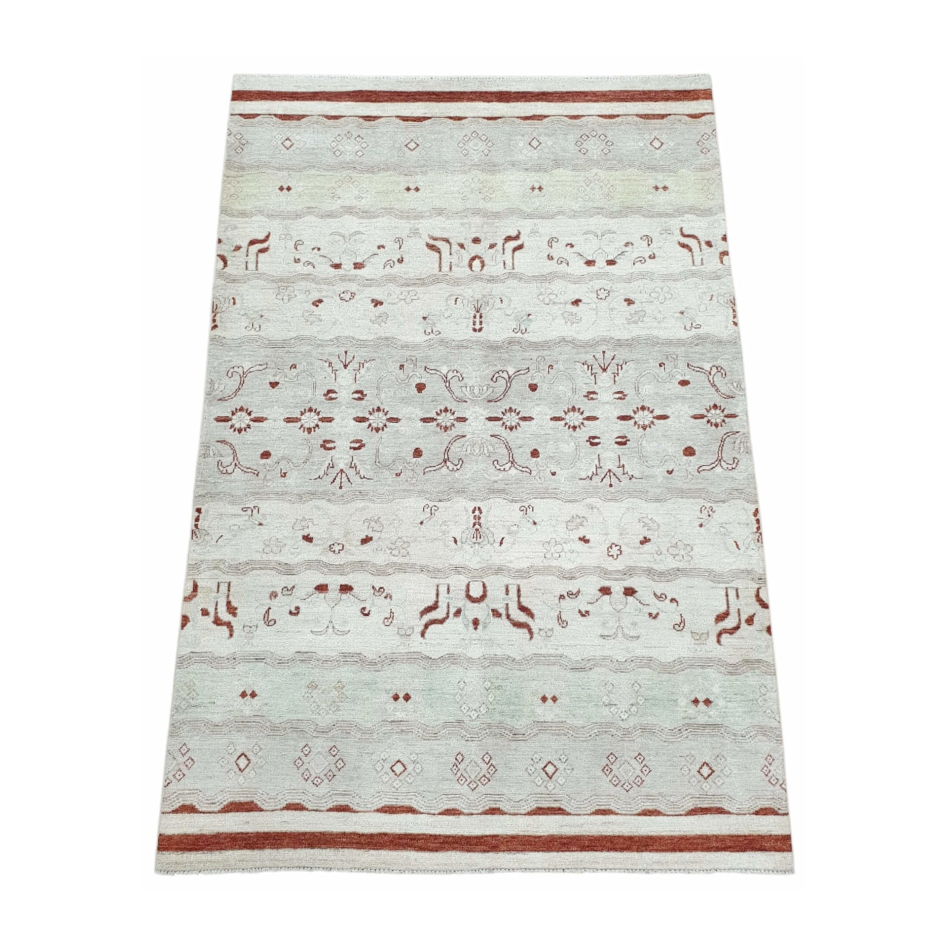Angled full view of Afghan Gabbeh wool rug showing tonal horizontal bands, rust-red motifs and soft off-white wool pile, 250 x 168 cm