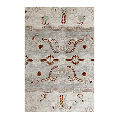 Central motif detail of Afghan Gabbeh wool rug showing rust-red floral forms and subtle tonal striations