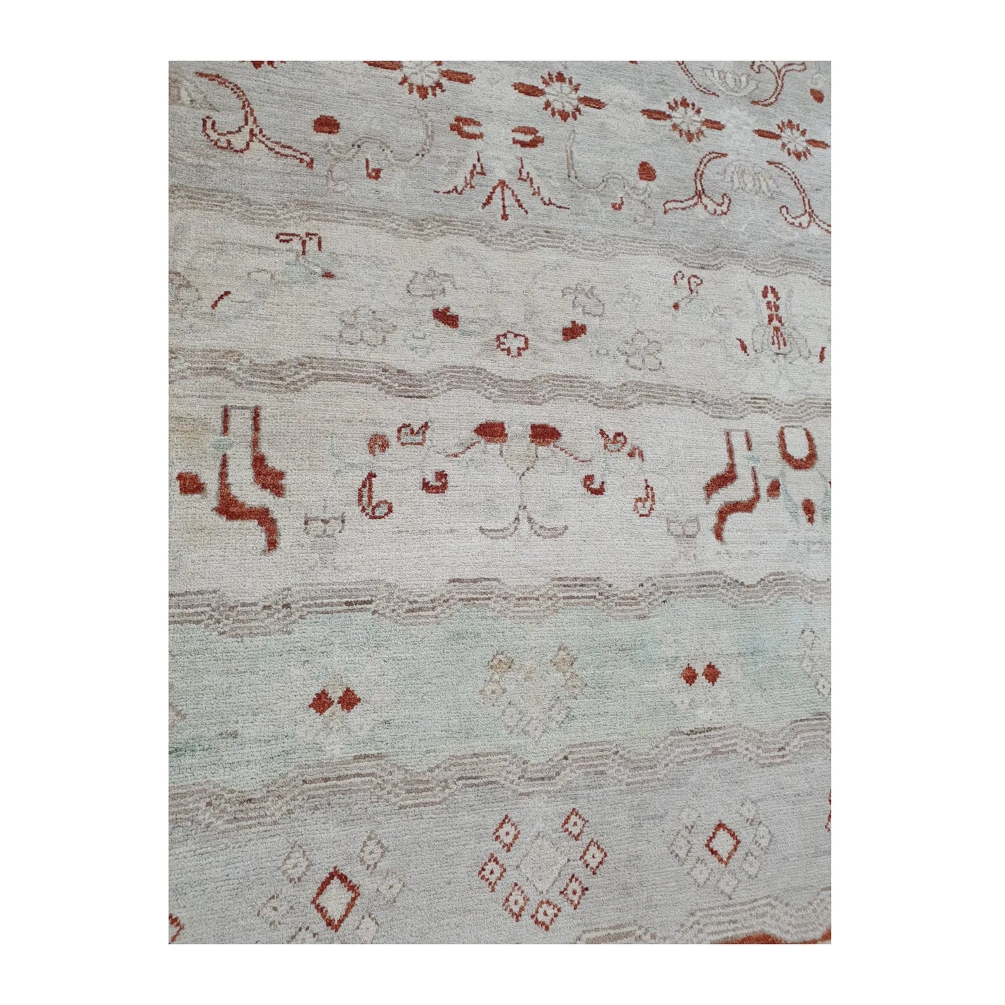 Lower-field pattern detail of Afghan Gabbeh wool rug showing pale mint band, rust-red motifs and geometric accents, 250 x 168 cm