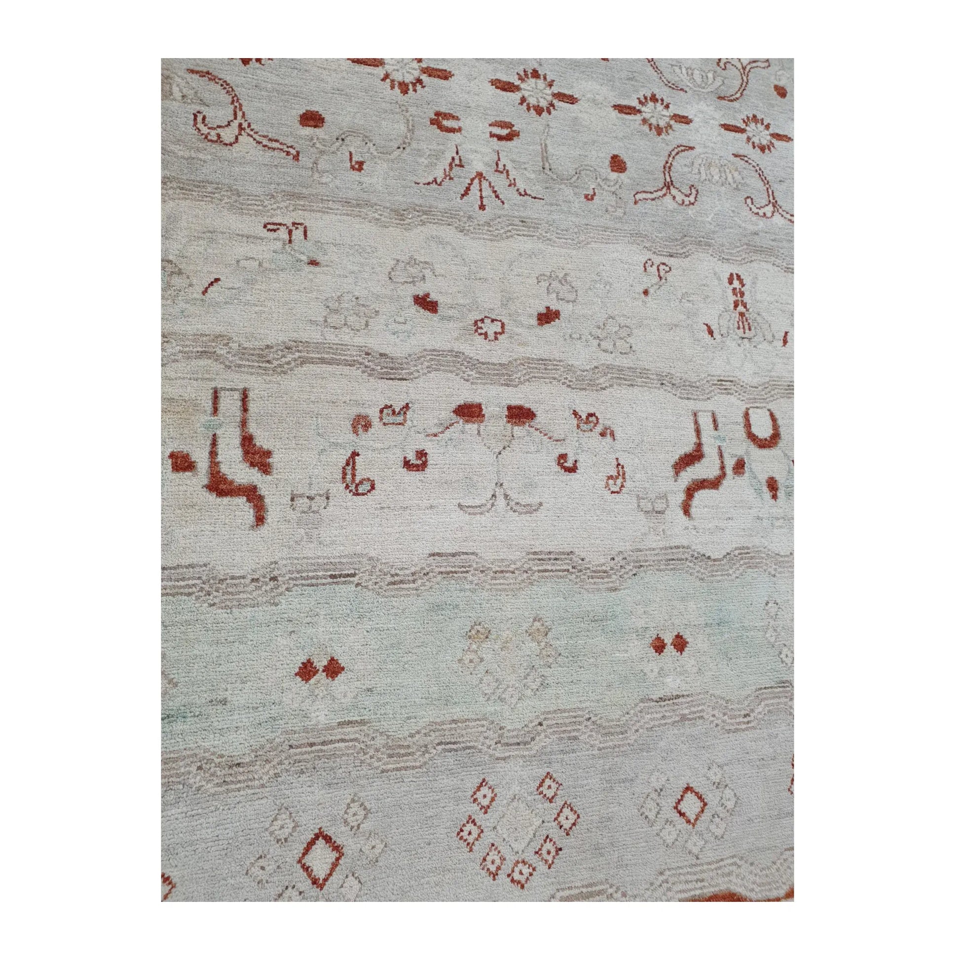 Lower-field pattern detail of Afghan Gabbeh wool rug showing pale mint band, rust-red motifs and geometric accents, 250 x 168 cm