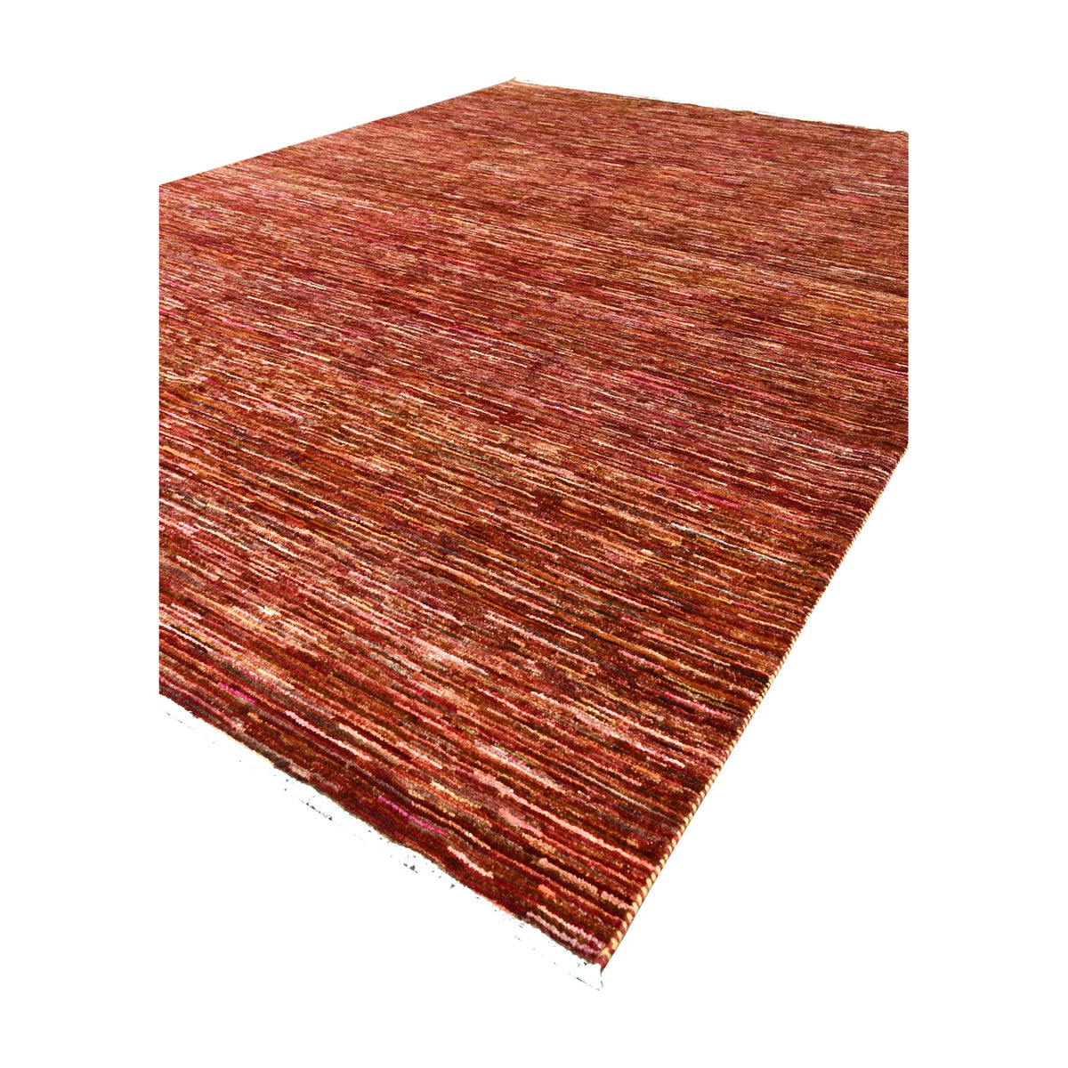 Angled full view of Afghan Gabbeh rug showing its borderless rust-red field and horizontal colour variation