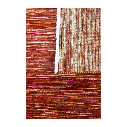 Folded fringe end of Afghan Gabbeh rug showing the rust-red face, reverse weave and ivory fringe