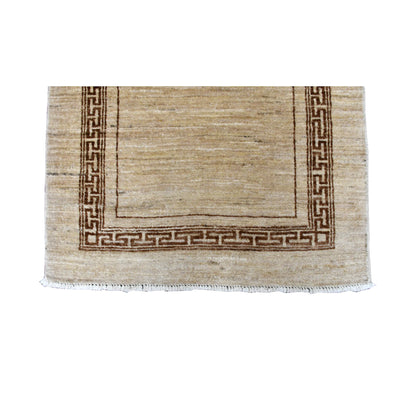 Fringe-end detail of Afghan Gabbeh runner showing the brown geometric border around its beige field and white fringe