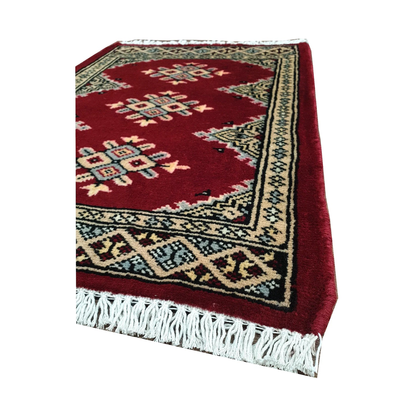 Angled fringe and border detail of Afghan Jaldar wool rug showing red pile, ivory diamond motifs and dark geometric edging