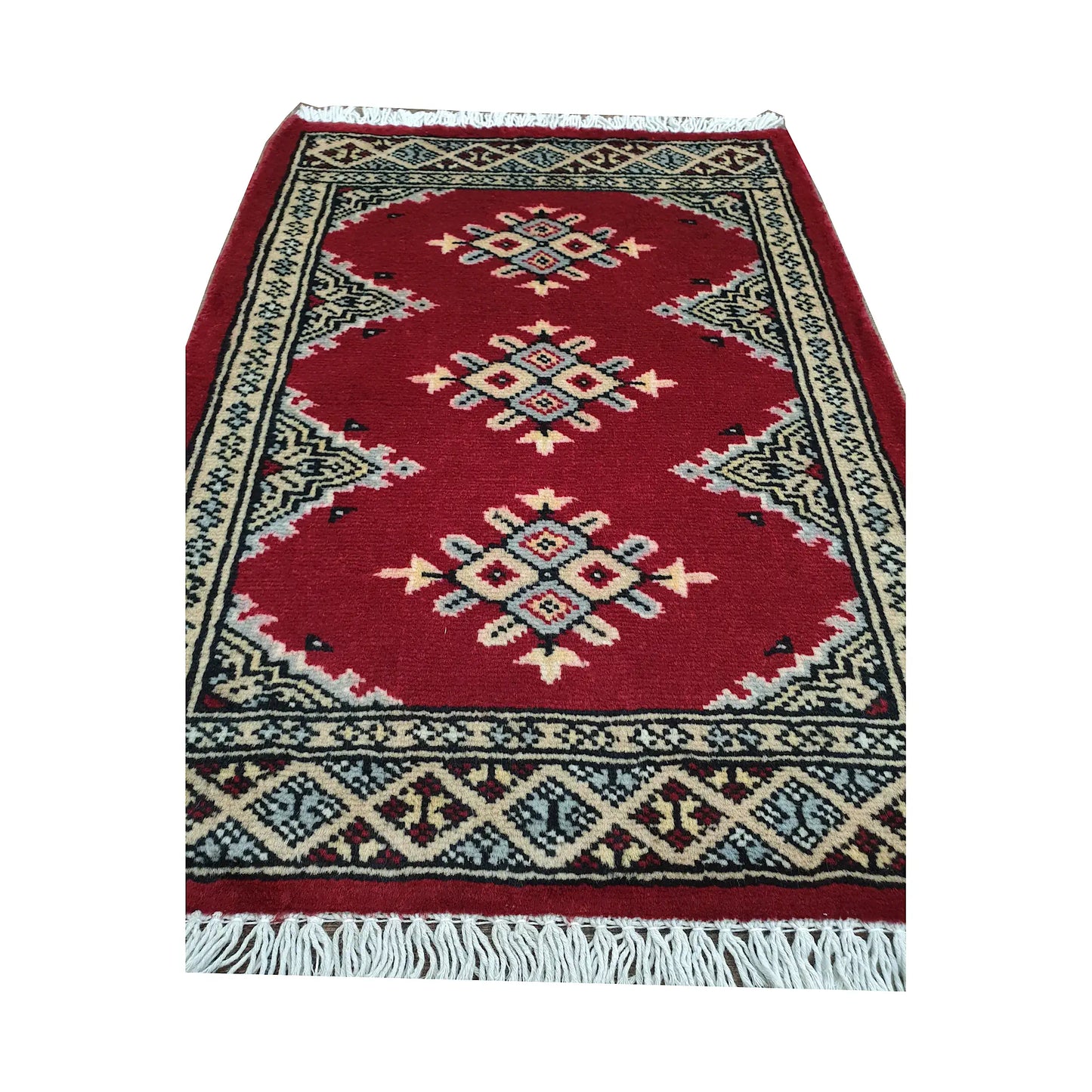 Red field and border detail of Afghan Jaldar wool rug showing ivory diamond medallions and traditional border pattern