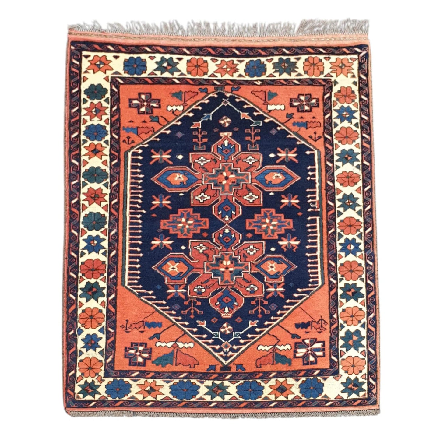 Full view of Afghan Karghai hand-knotted wool rug with warm orange field, navy medallion and cream floral border, 138 x 108 cm