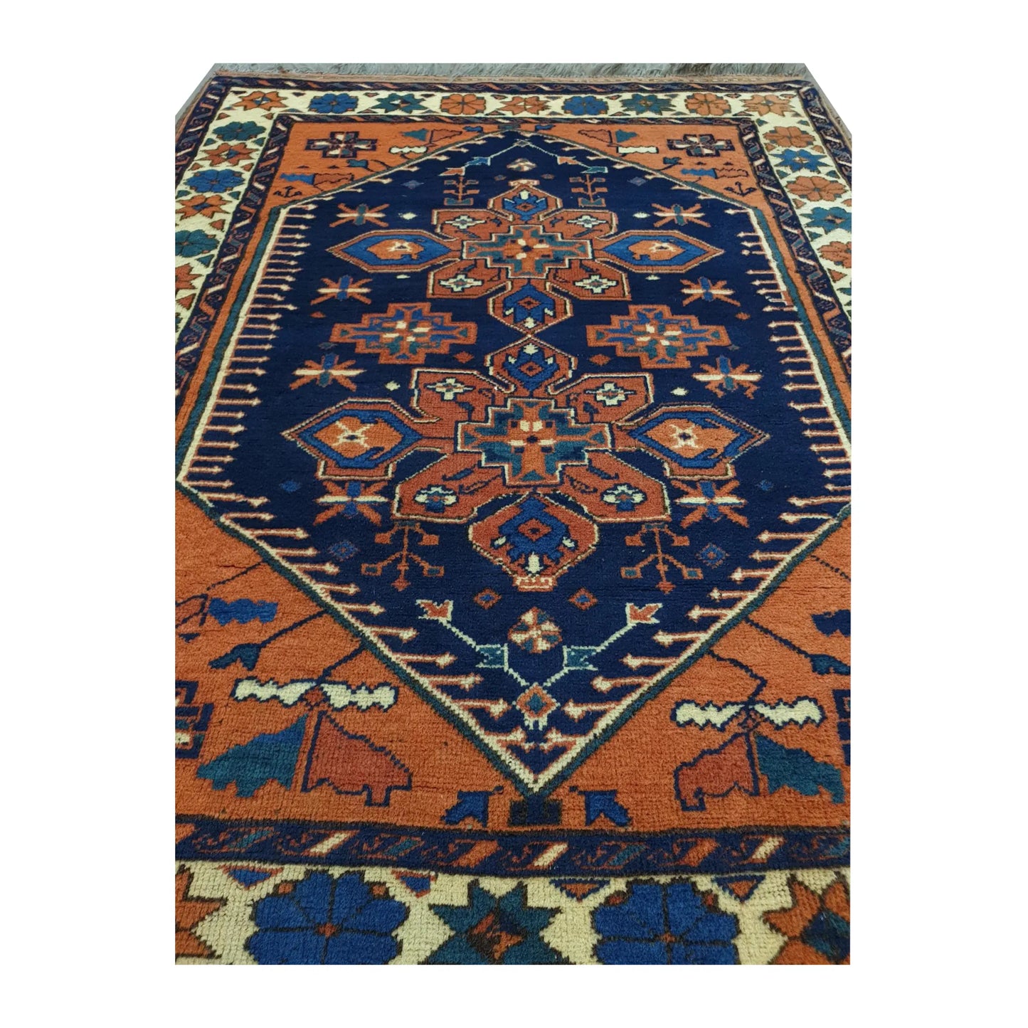 Close-up of Afghan Karghai wool rug showing the detailed navy floral medallion, orange field and border motifs