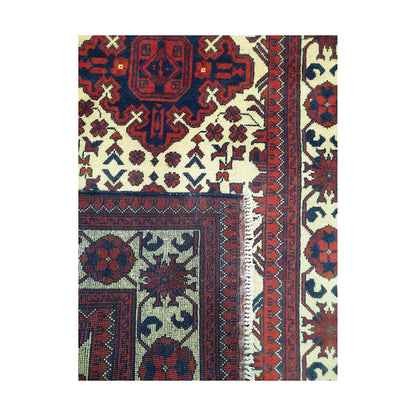 Folded corner detail of Afghan Karghai runner rug showing the back of the rug, fringe and front border pattern