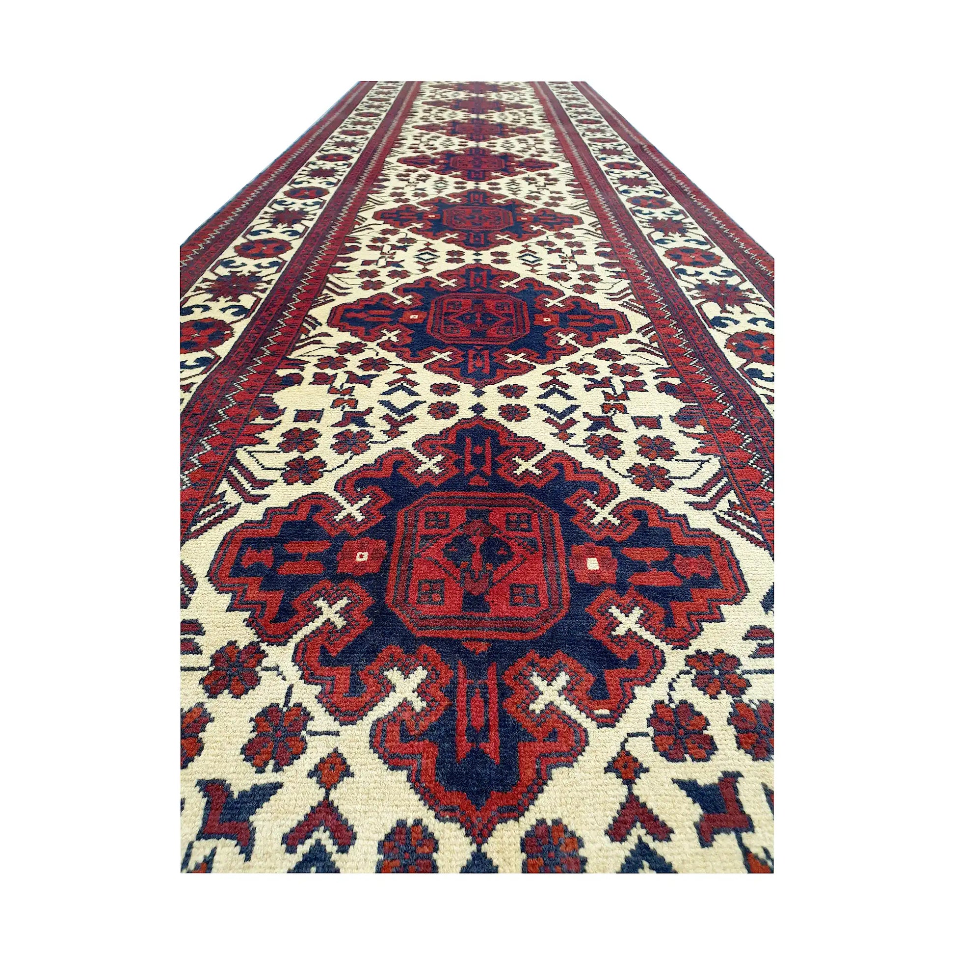 Close-up of Afghan Karghai runner rug showing burgundy medallion, ivory field and detailed border pattern