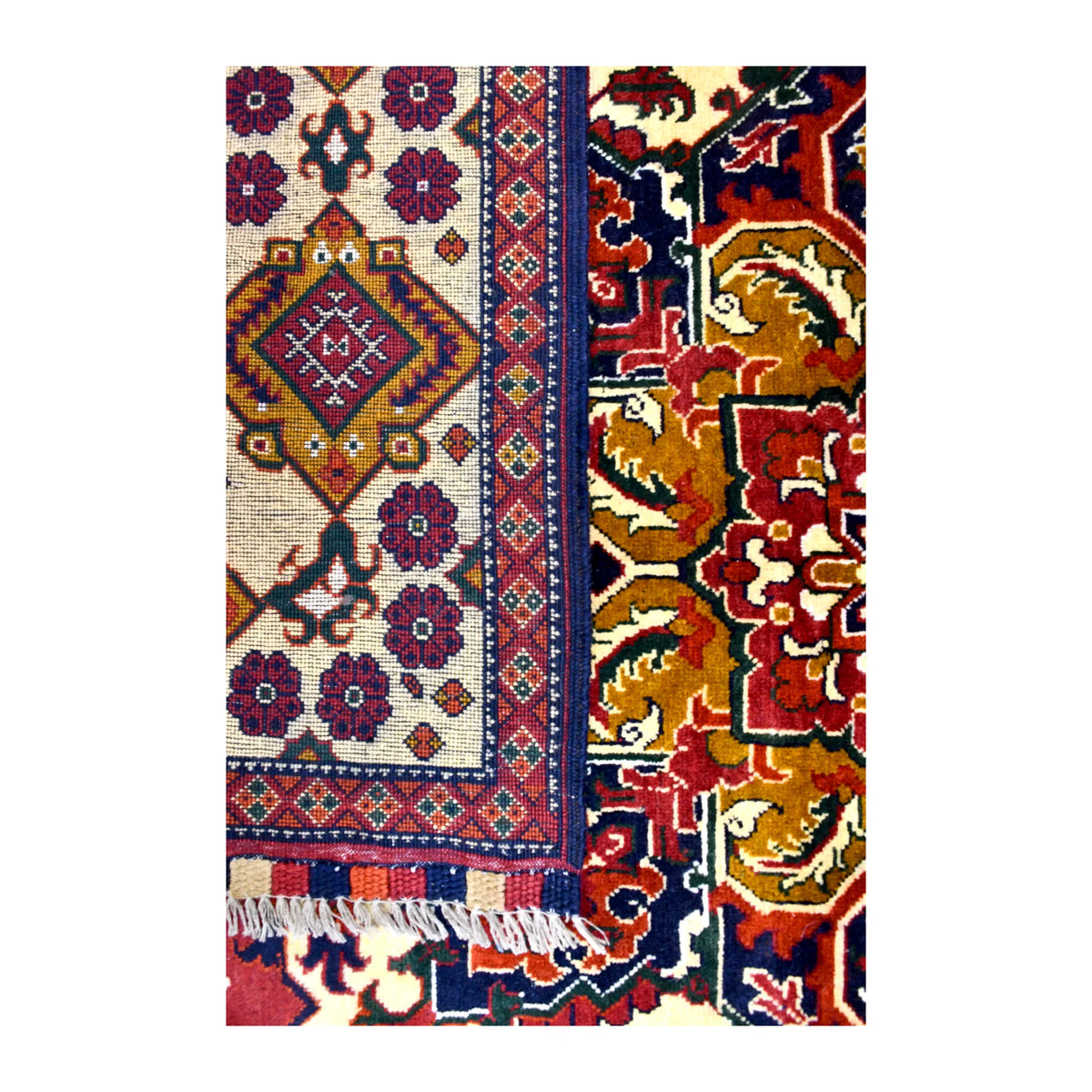 Folded-corner detail of Afghan Karghai rug showing the patterned reverse beside its red field and ivory diamond border