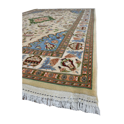 Angled view of Afghan Karghai rug showing its beige floral field, pale blue corner, layered border and white fringe