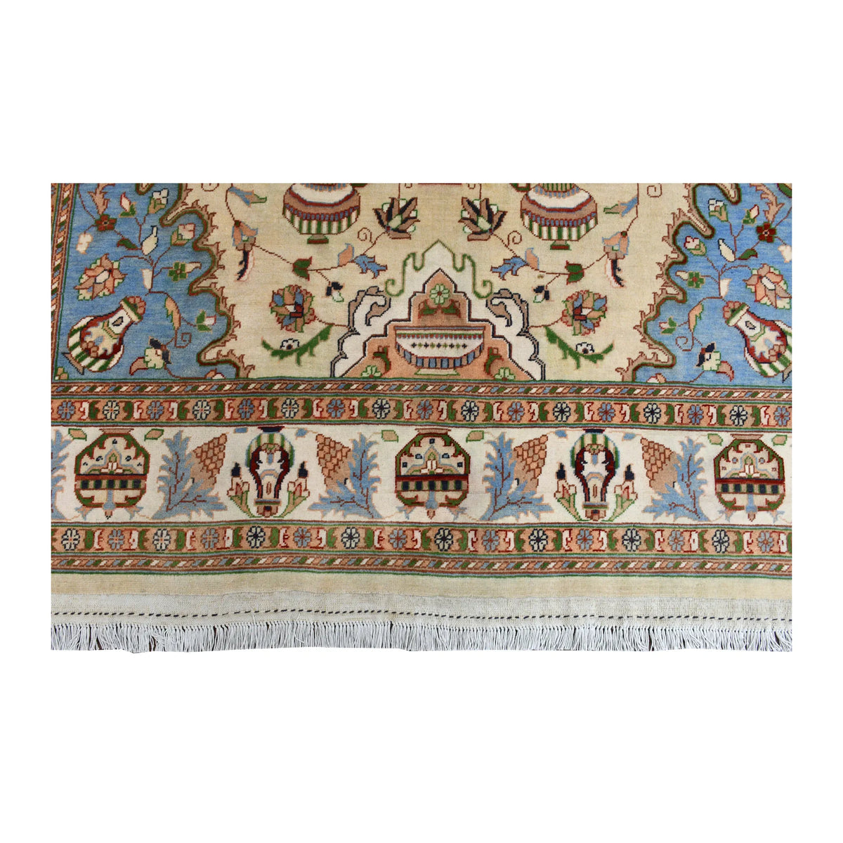 End-border detail of Afghan Karghai rug showing vase motifs, a patterned ivory border and white fringe
