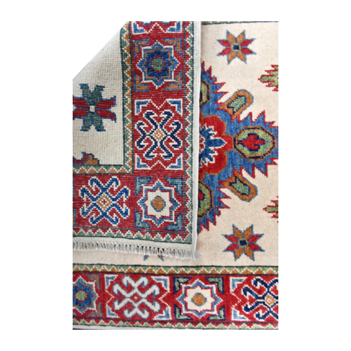 Folded-corner detail of Afghan Kazak runner showing the reverse weave beside its cream patterned front and red-blue border