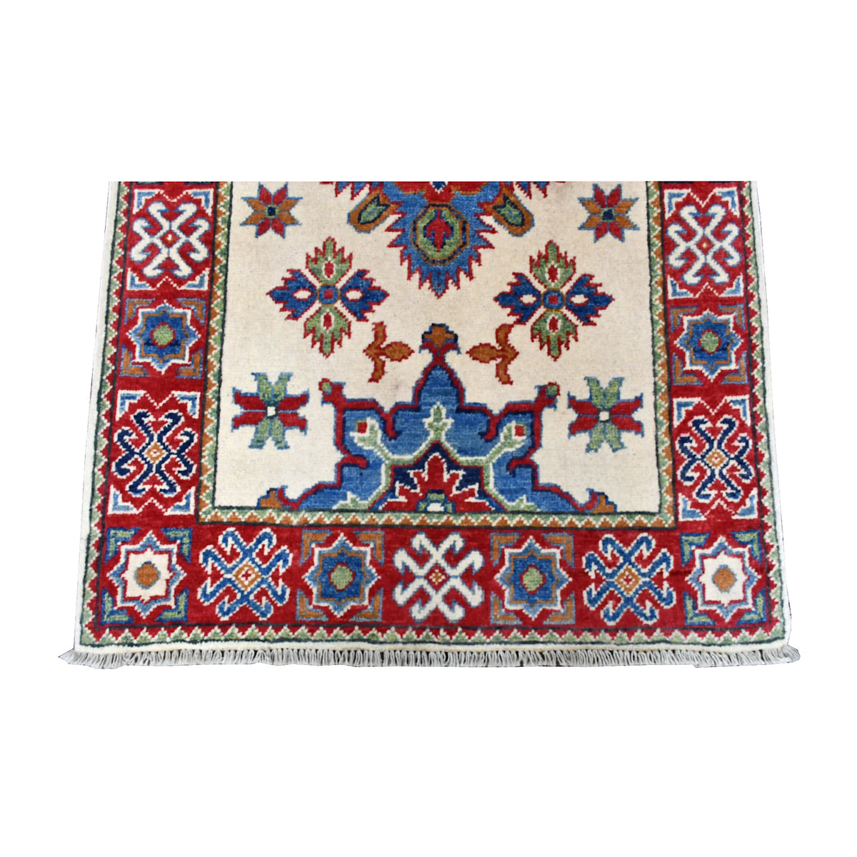 Fringe-end detail of Afghan Kazak runner showing red and blue angular border motifs around the cream field
