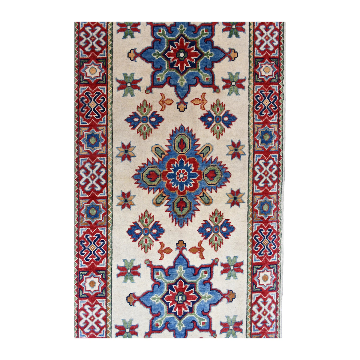 Field detail of Afghan Kazak runner showing blue and red medallions, small star motifs and patterned borders on cream