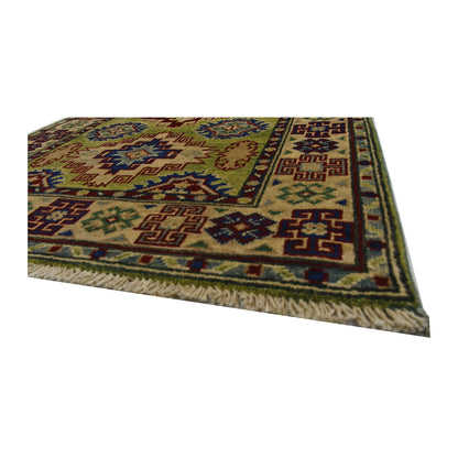 Angled corner and fringe view of Afghan Kazak wool rug showing golden beige field, patterned border and light fringe