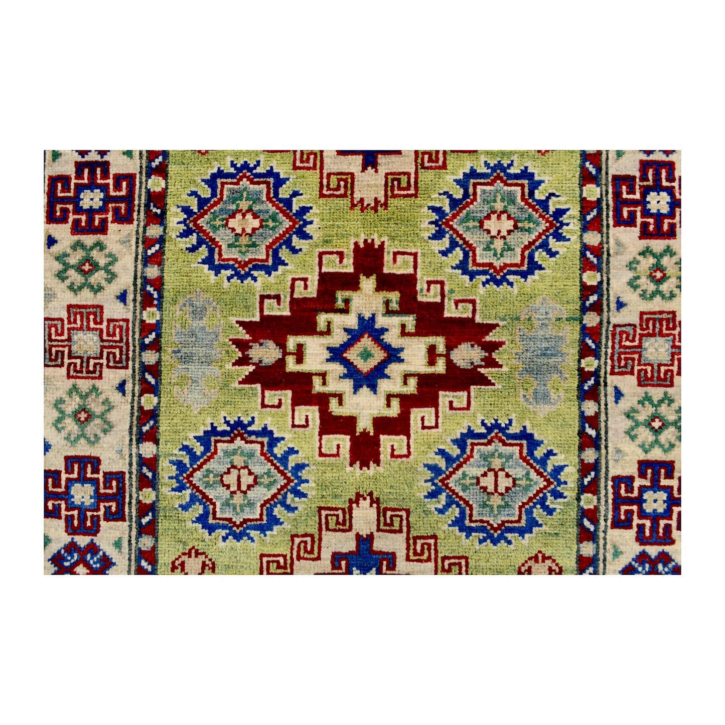Central medallion detail of Afghan Kazak wool rug showing red, blue, cream and muted green geometric motifs