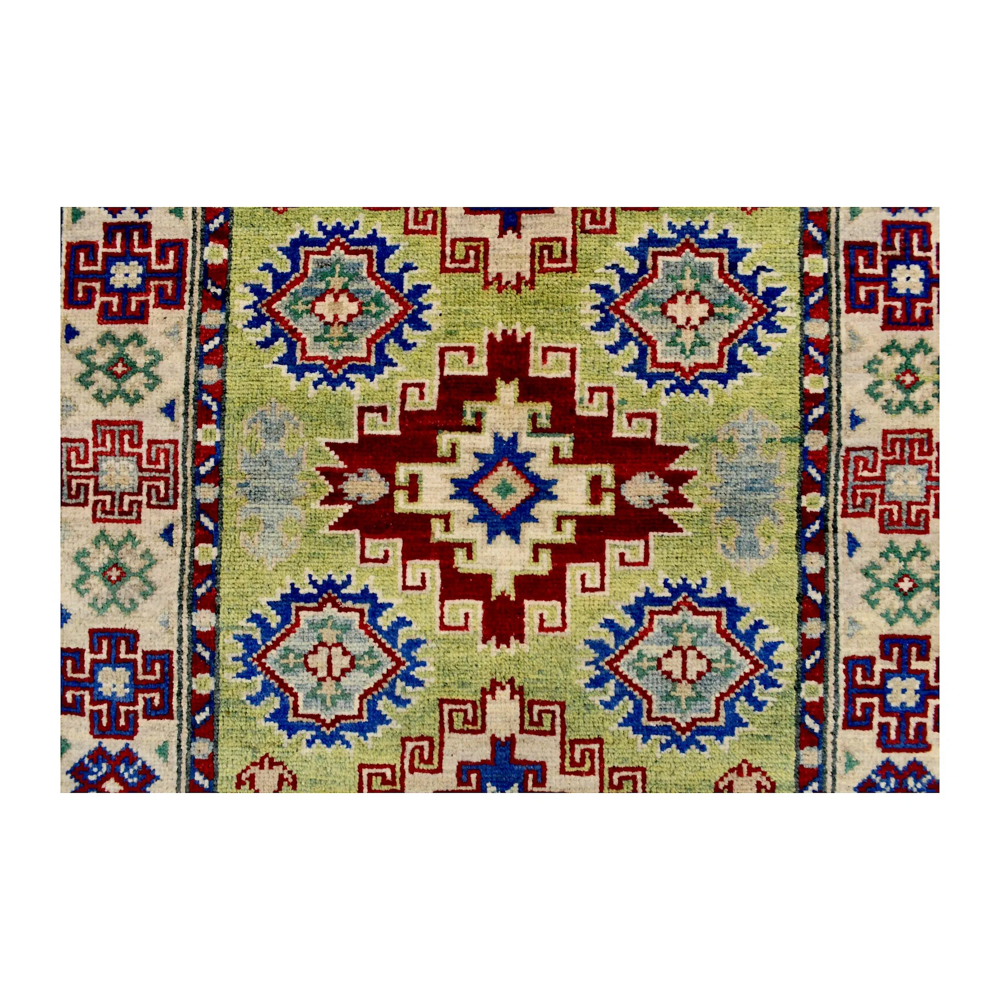 Central medallion detail of Afghan Kazak wool rug showing red, blue, cream and muted green geometric motifs