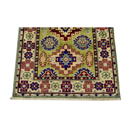 End field and border detail of Afghan Kazak hand-knotted wool rug showing geometric motifs, golden beige ground and red-blue accents