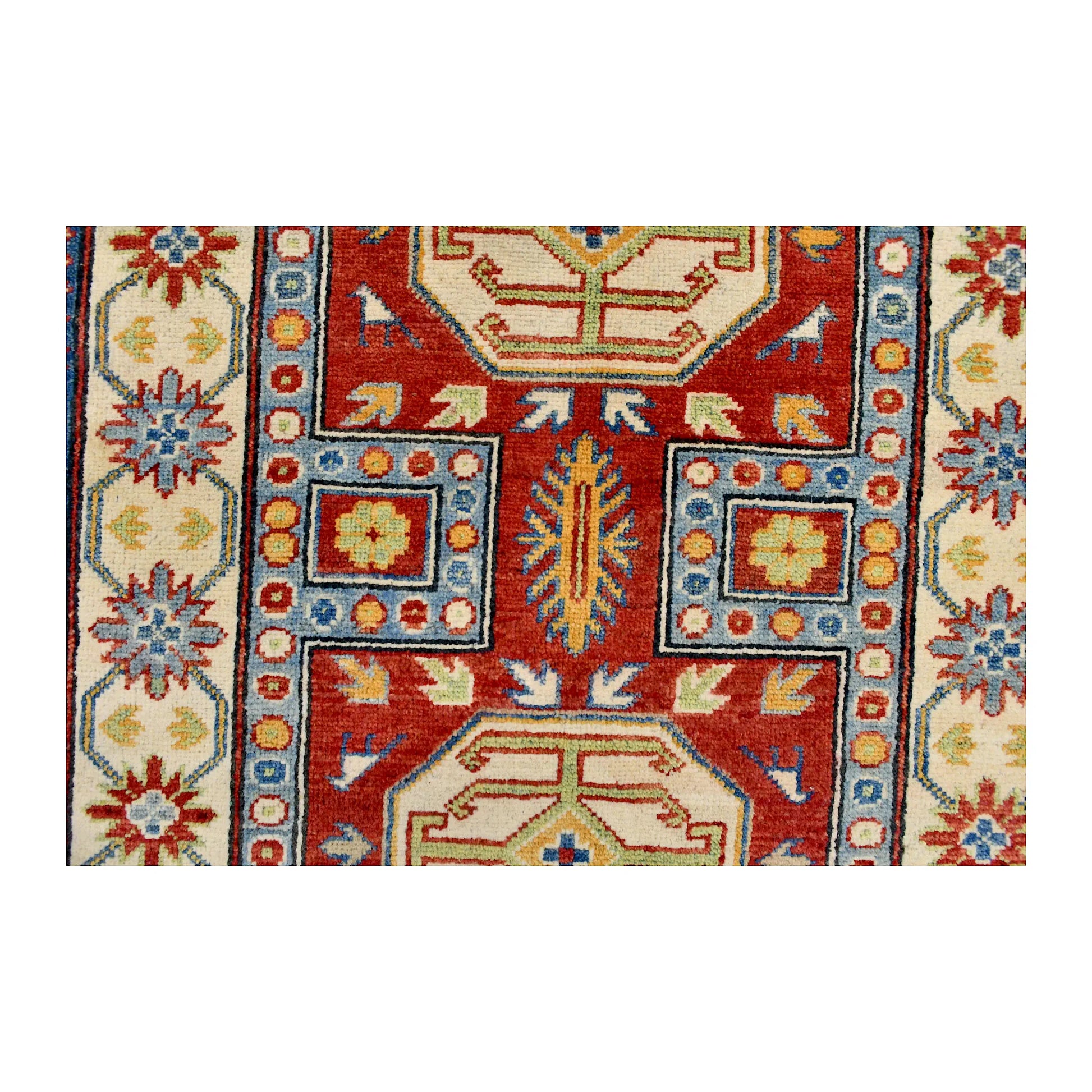 Field and medallion detail of Afghan Kazak hand-knotted wool rug showing red, blue and muted green geometric motifs