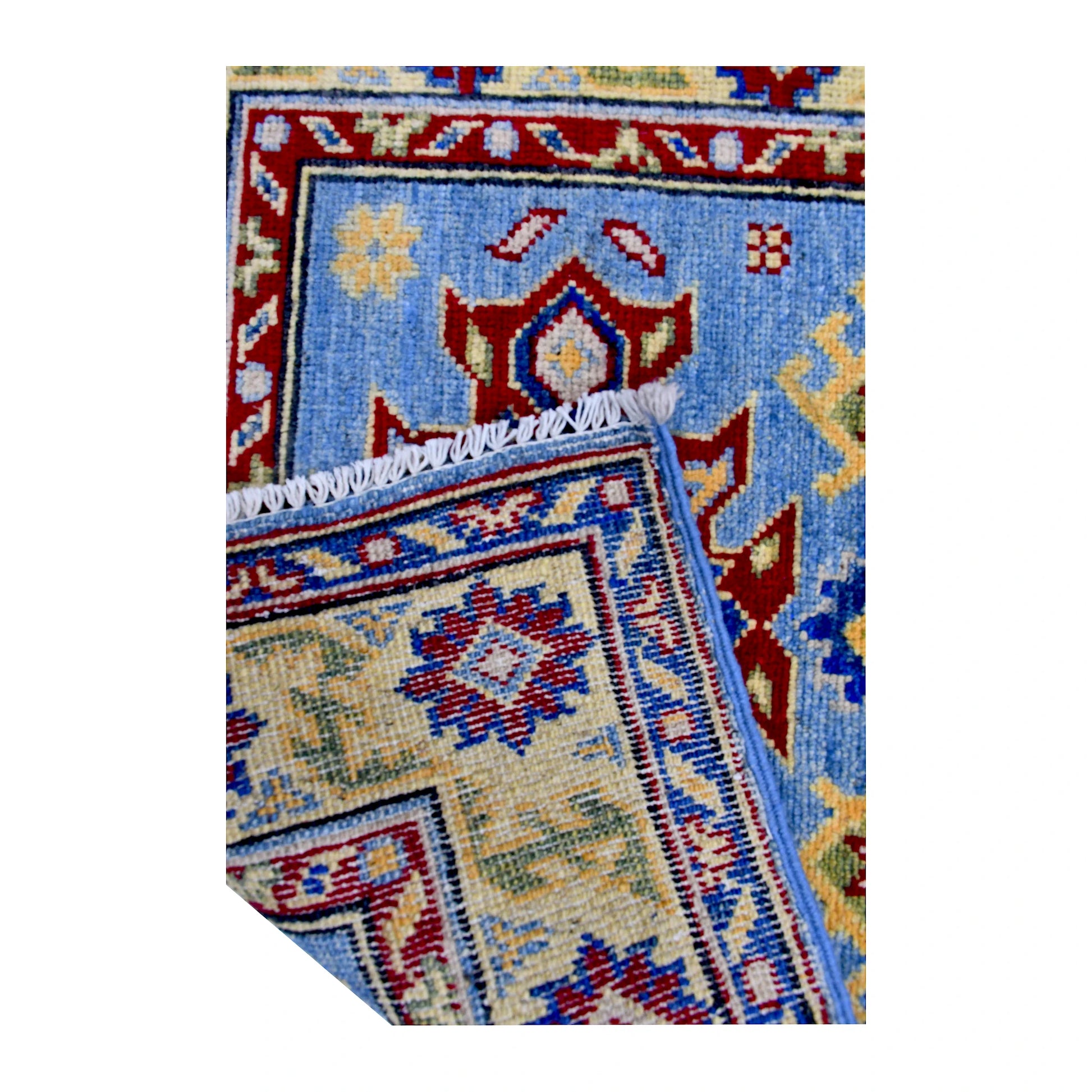 Folded corner reverse-weave detail of Afghan Kazak hand-knotted wool rug showing the back structure, pattern and weave
