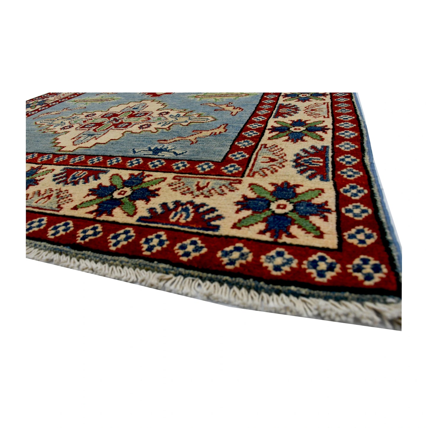 Angled corner and fringe view of Afghan Kazak wool rug showing light blue field, red border and ivory fringe