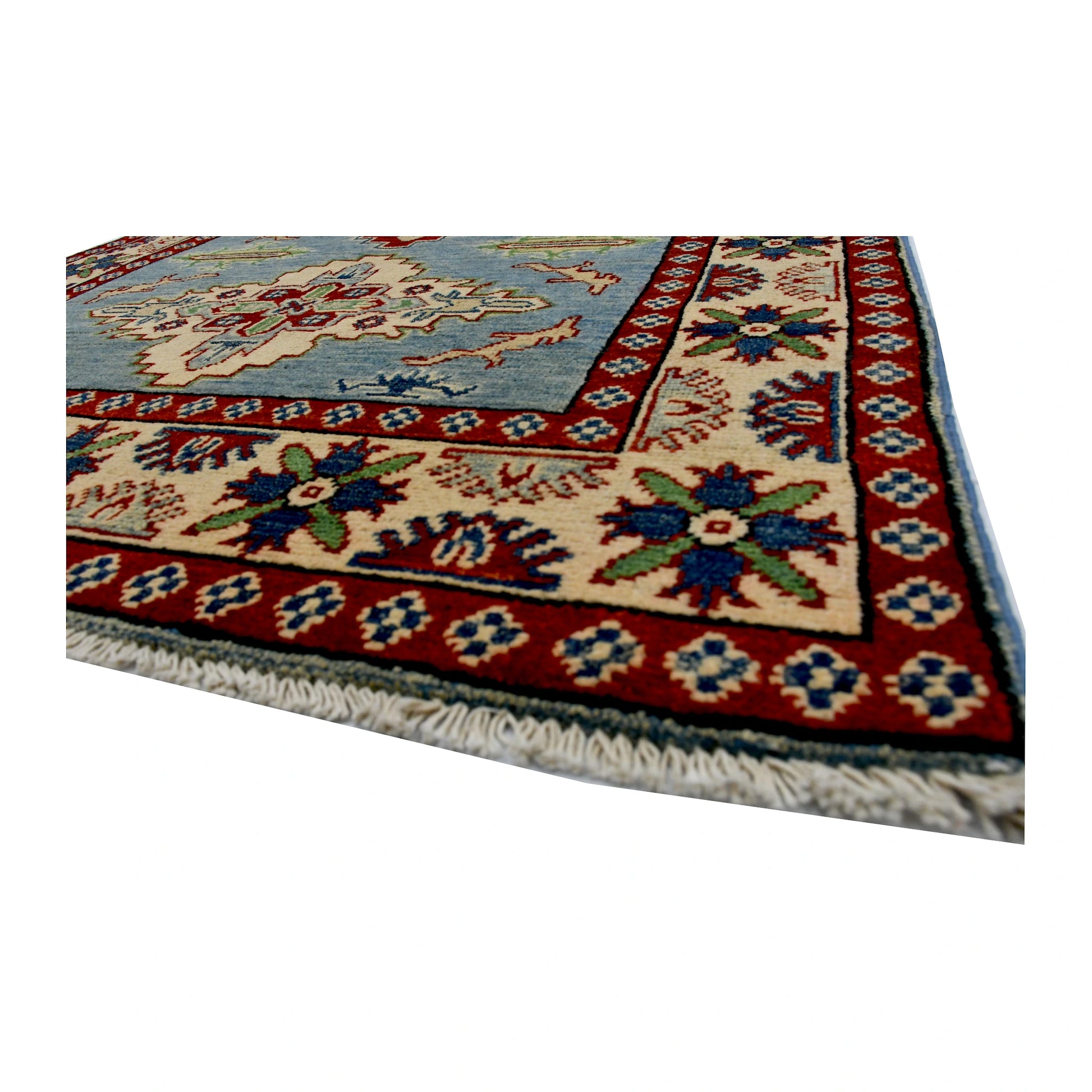 Angled corner and fringe view of Afghan Kazak wool rug showing light blue field, red border and ivory fringe
