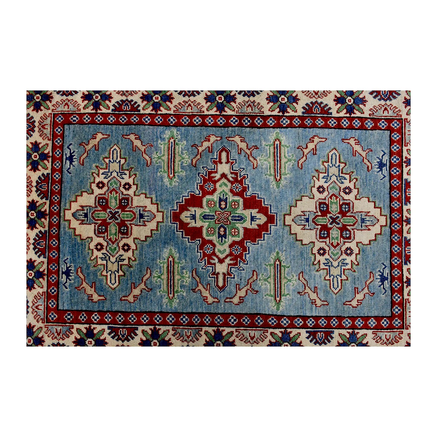 Full design detail of Afghan Kazak hand-knotted wool rug showing three geometric medallions on a light blue field