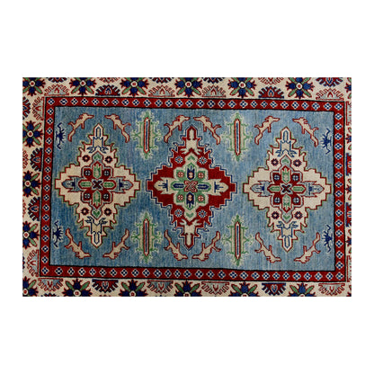 Full design detail of Afghan Kazak hand-knotted wool rug showing three geometric medallions on a light blue field