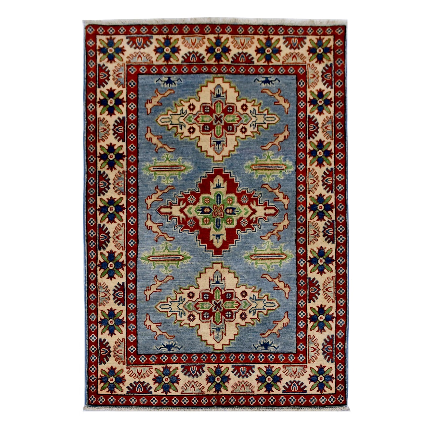 Full view of Afghan Kazak hand-knotted wool rug with light blue field, geometric medallions and red border, 150 x 102 cm