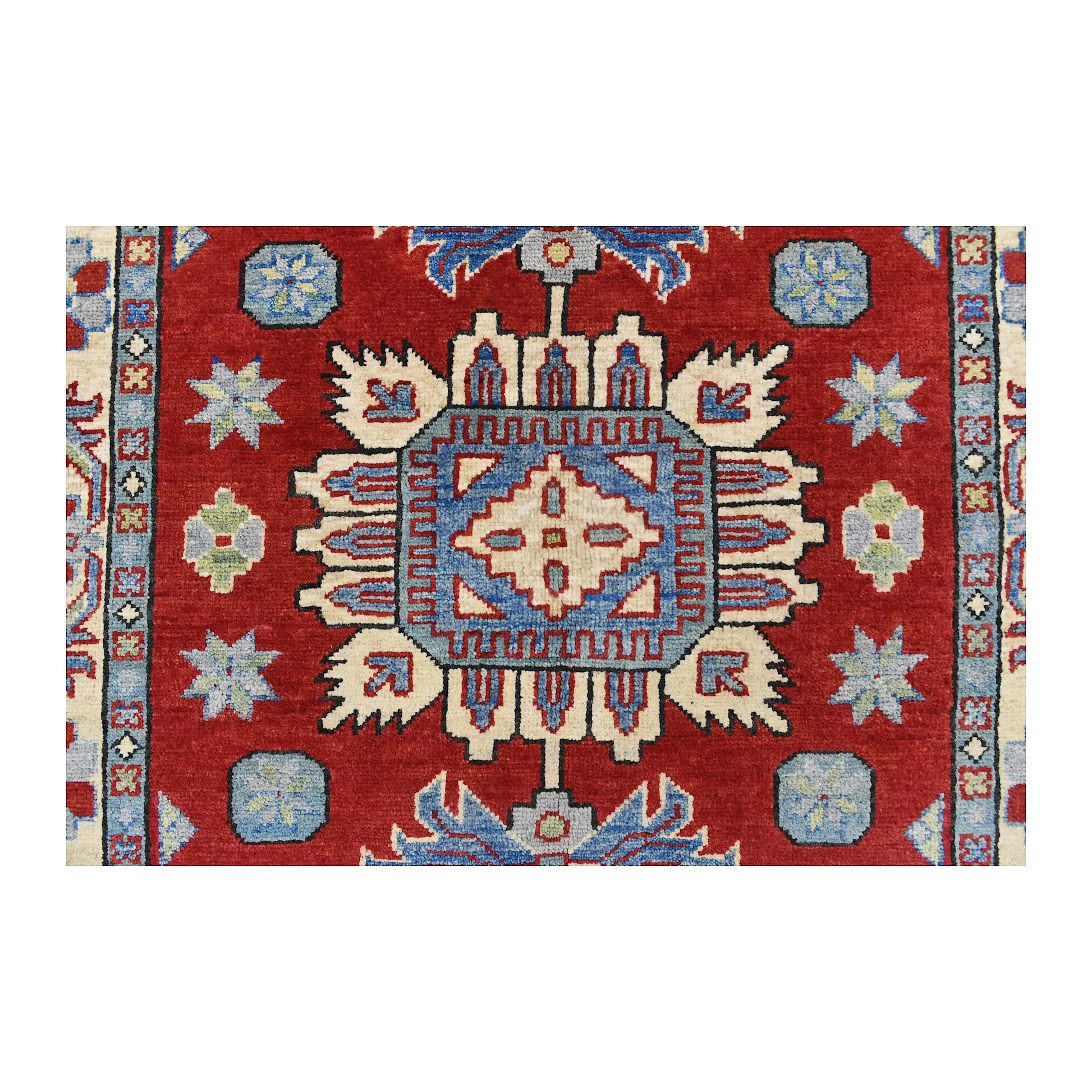 Central medallion detail of Afghan Kazak wool rug showing light blue, cream, navy and muted green geometric motifs