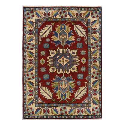 Full view of Afghan Kazak hand-knotted wool rug with red field, three geometric medallions and cream border, 154 x 105 cm