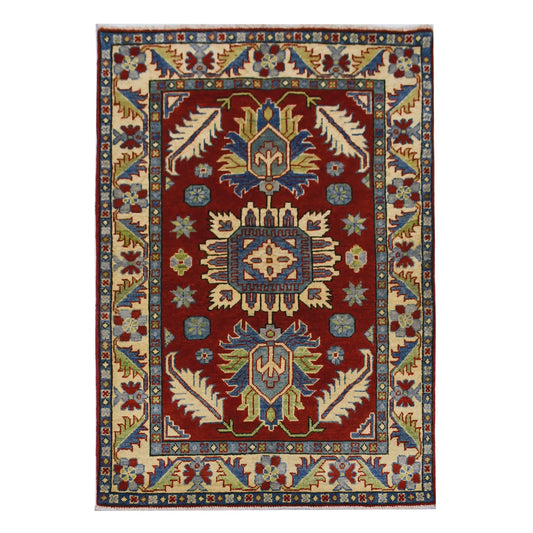 Full view of Afghan Kazak hand-knotted wool rug with red field, three geometric medallions and cream border, 154 x 105 cm