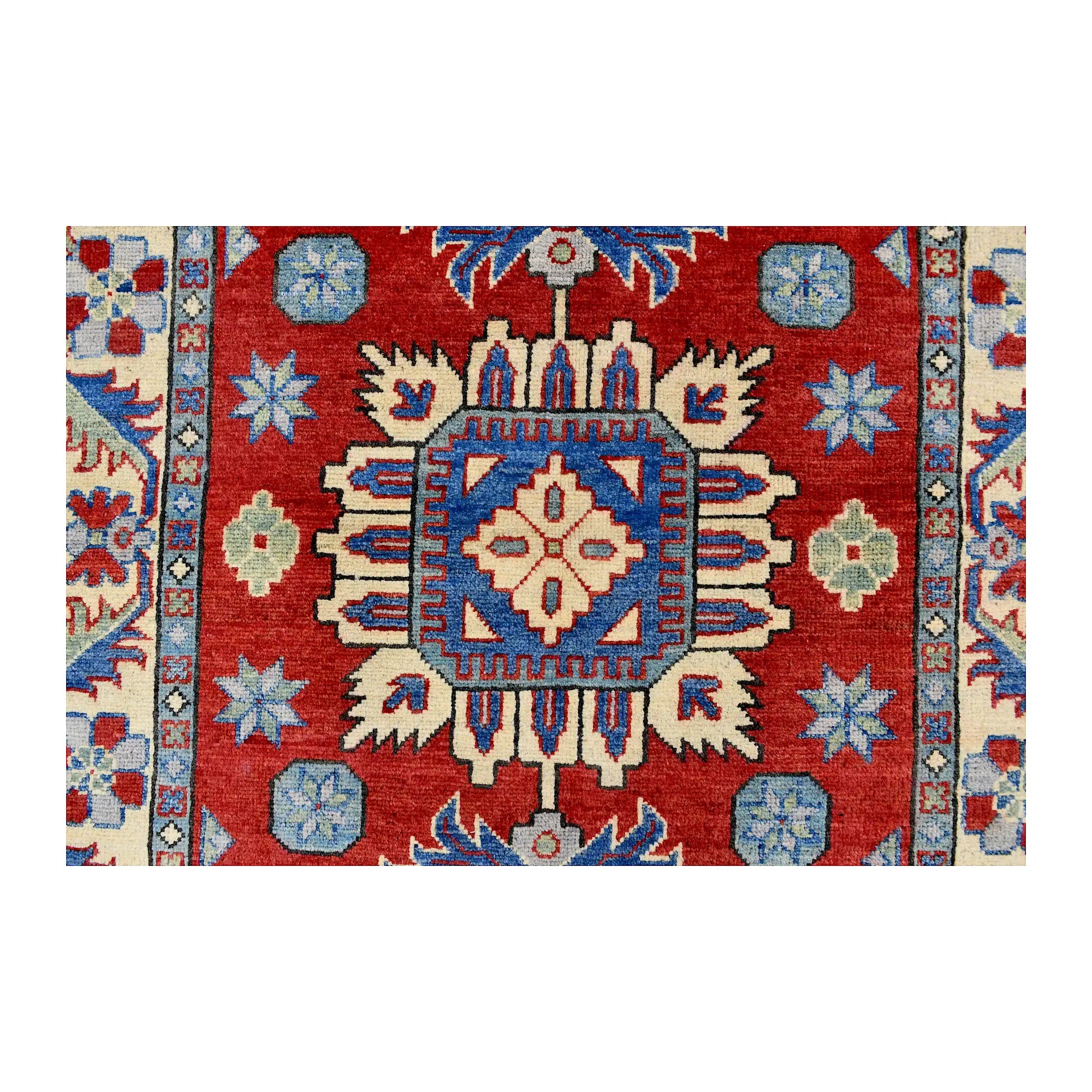 Central medallion detail of Afghan Kazak wool rug showing blue, cream, navy and ivory geometric motifs