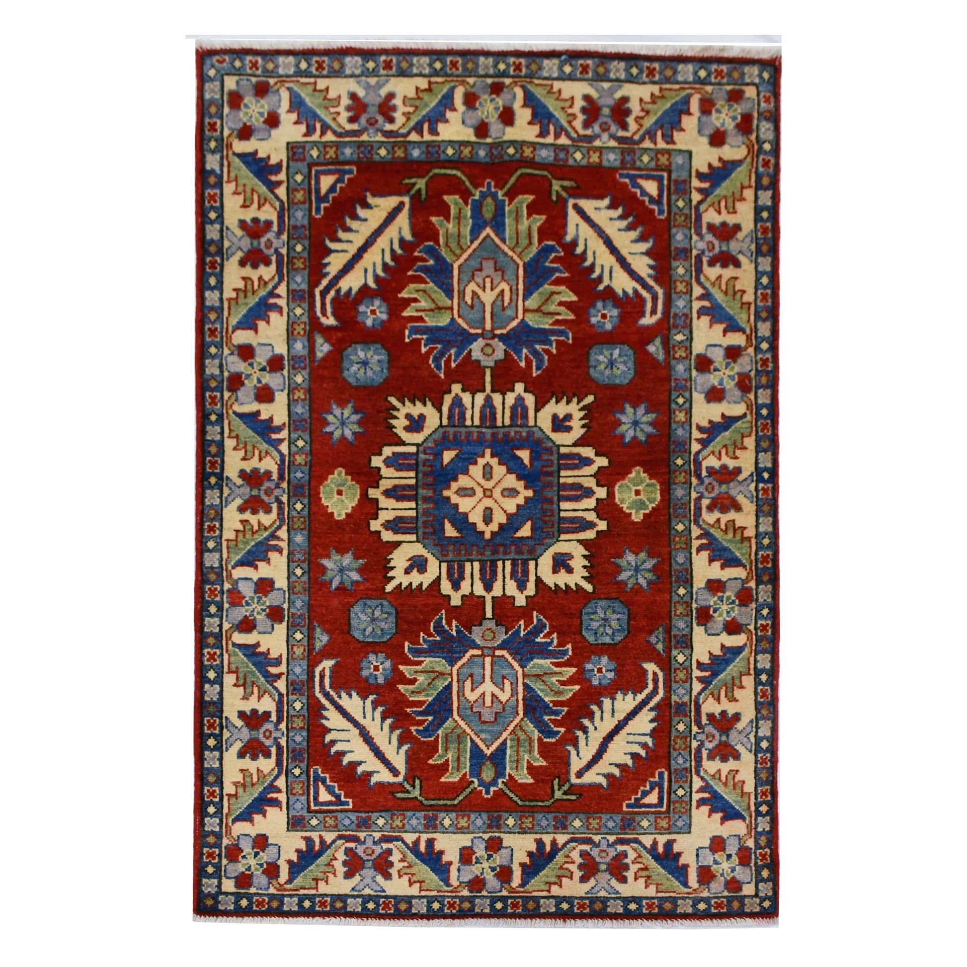 Full view of Afghan Kazak hand-knotted wool rug with red field, geometric medallions and cream border, 156 x 100 cm