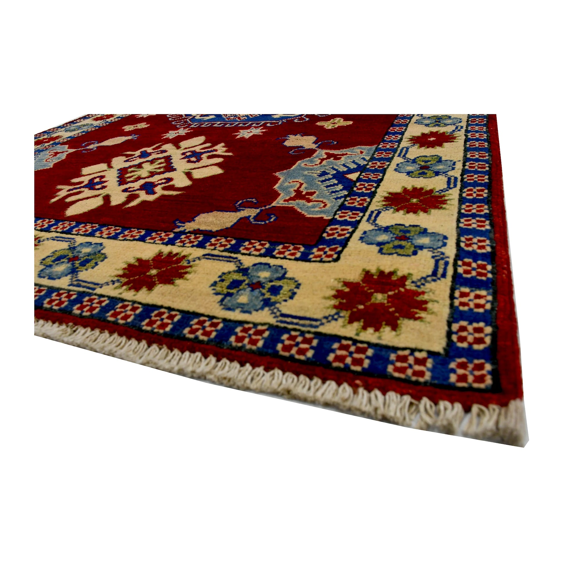 Angled corner and fringe view of Afghan Kazak wool rug showing red field, cream border and light fringe