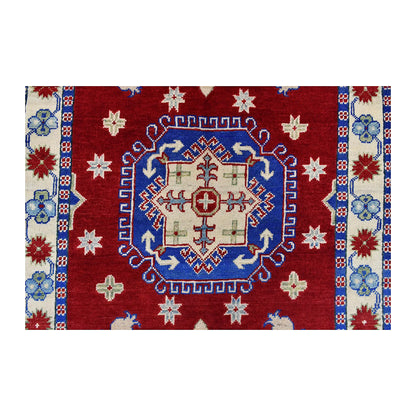 Central medallion detail of Afghan Kazak wool rug showing blue, cream, navy and ivory geometric motifs