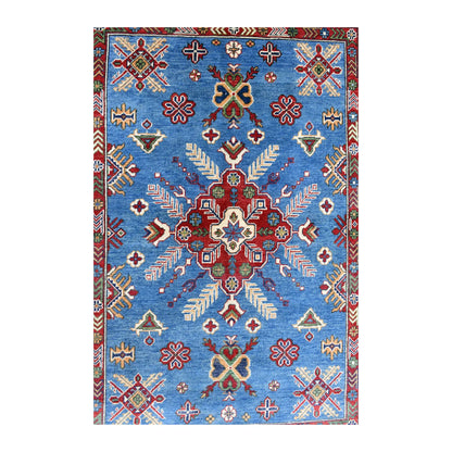 Field detail of Afghan Kazak rug showing the red star medallion and scattered geometric motifs on a sky-blue ground