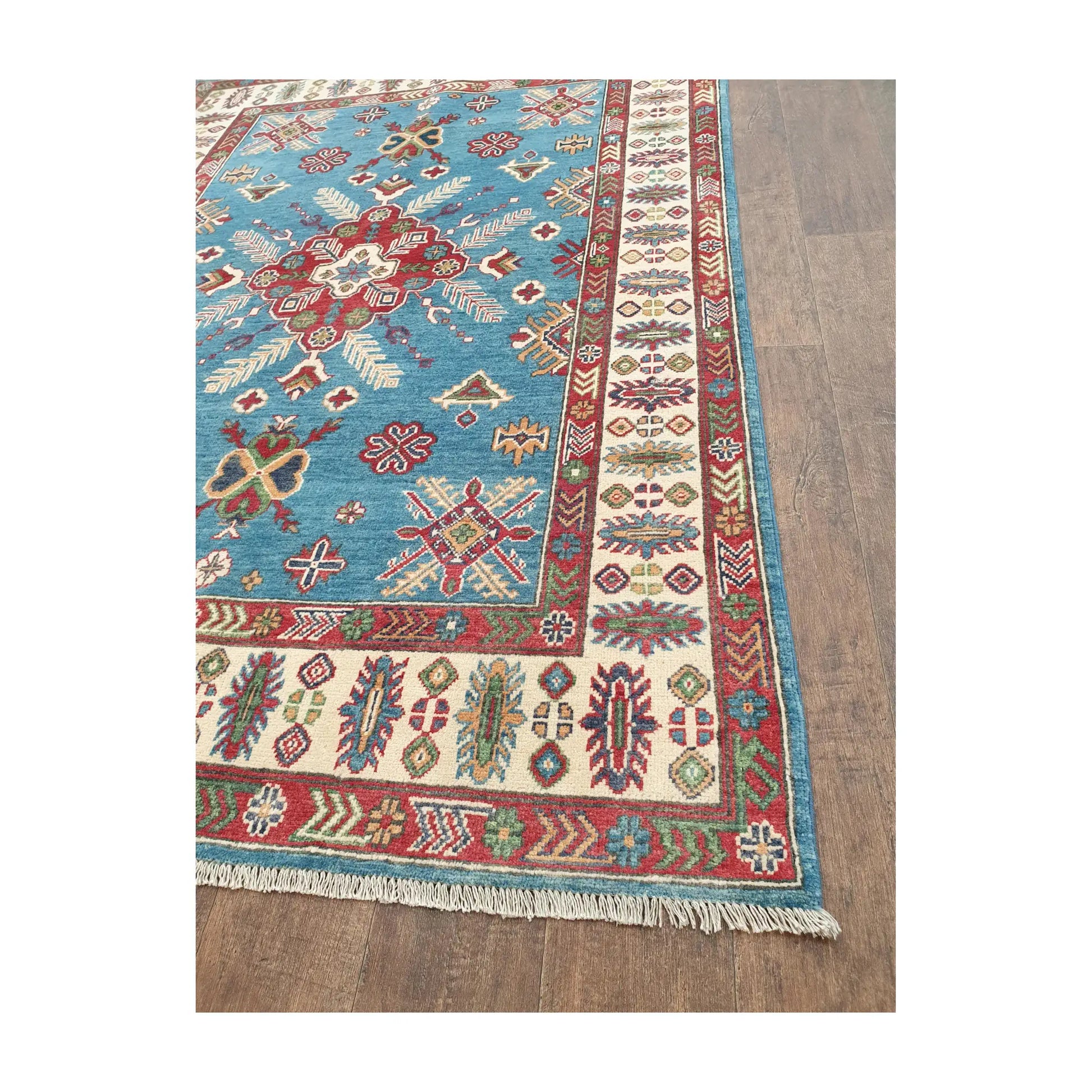 Border and fringe detail of Afghan Kazak hand-knotted wool rug with cream and red pattern